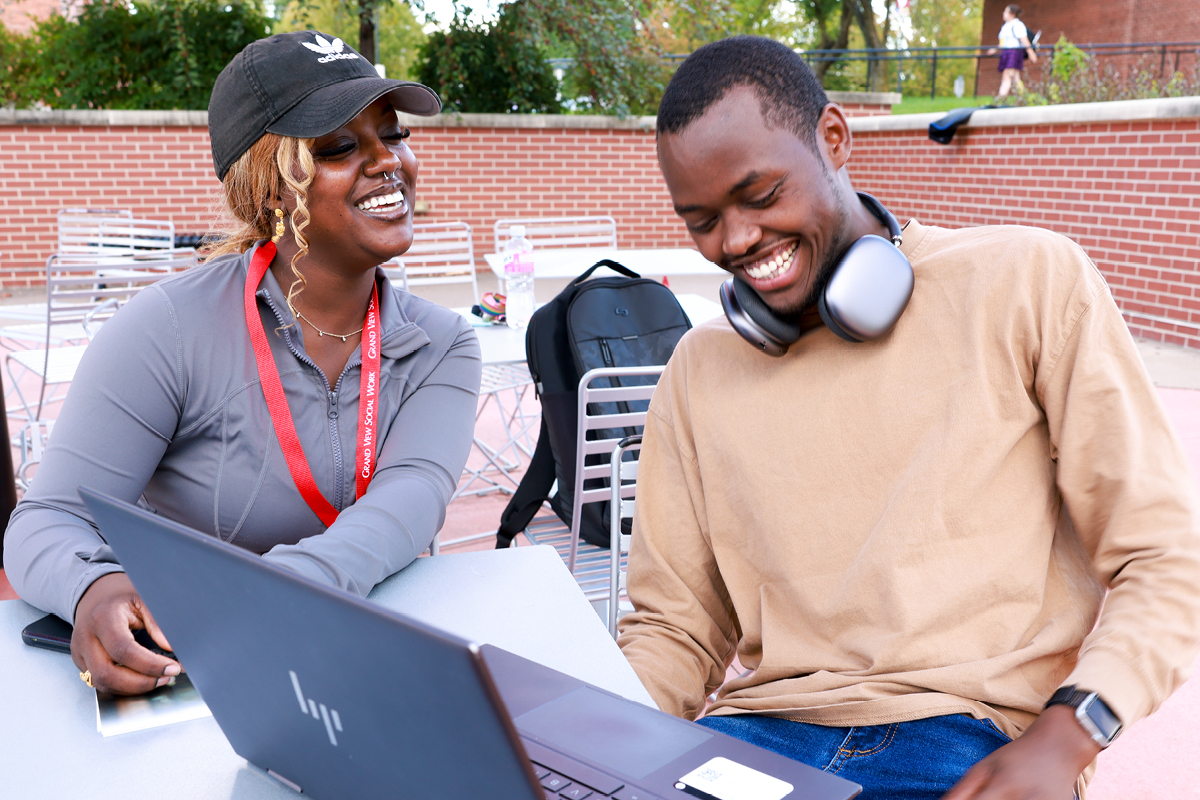 Grand View University students smiling while studying together on Grand Central Plaza.